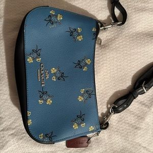 Light blue Coach purse with flower, and shoulder strap